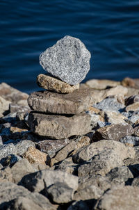 Close-up of stone stack on rock in sea