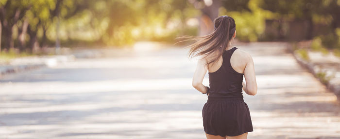 Rear view of woman standing outdoors