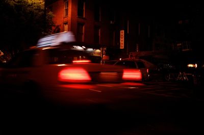 Cars on illuminated street at night