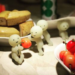 Close-up of figurines and fruits on table