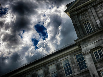 Low angle view of building against cloudy sky