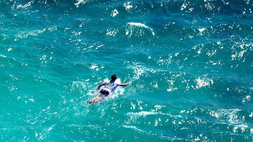 High angle view of man swimming in sea 