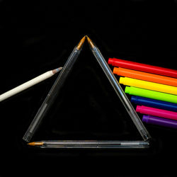Close-up of multi colored pencils against black background