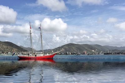 Sailing ship in sea against sky