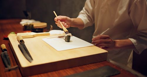 Midsection of man working on table