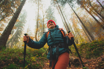 Full length of man standing in forest