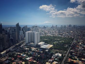 High angle view of modern buildings in city against sky