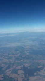 Aerial view of landscape against blue sky