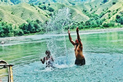 Full length of shirtless man in water