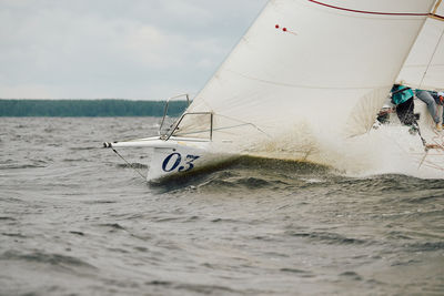Boat sailing on sea against sky