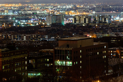 High angle view of illuminated buildings in city at night