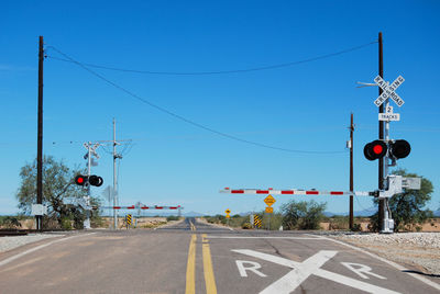 Road signs against clear blue sky