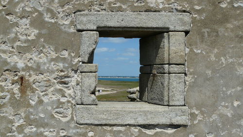 Close-up of old stone wall against sky