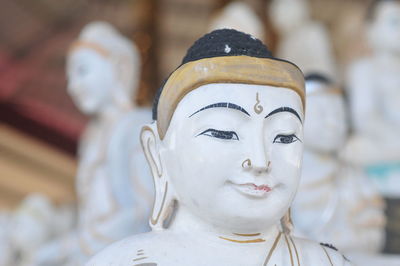 Close-up of buddha statue against temple