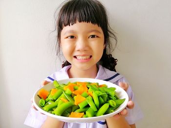 Portrait of a smiling girl holding food