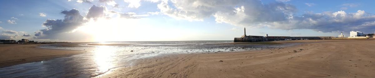 Panoramic view of beach against sky during sunset