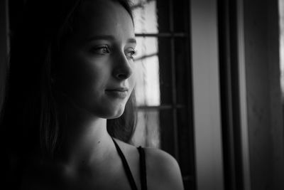 Portrait of woman looking away at home