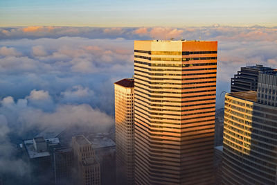 Buildings against sky at sunset