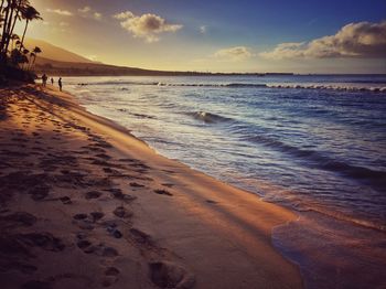 Scenic view of beach at sunset