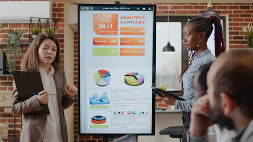 Businesswomen giving presentation during meeting