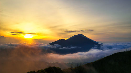 Scenic view of silhouette mountains against sky during sunset