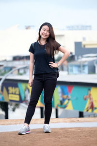 Portrait of smiling young woman standing outdoors