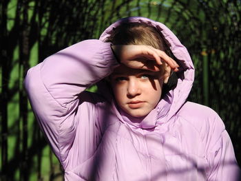 Portrait of girl hood against plants