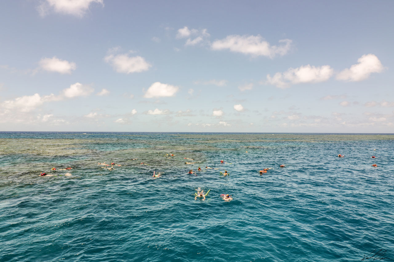 SCENIC SWIMMING IN SEA AGAINST SKY