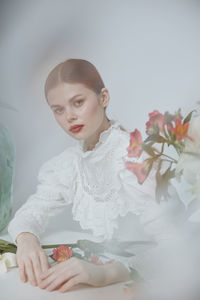 Portrait of young woman holding bouquet