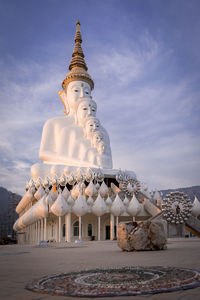 Low angle view of buddhist temple against cloudy sky