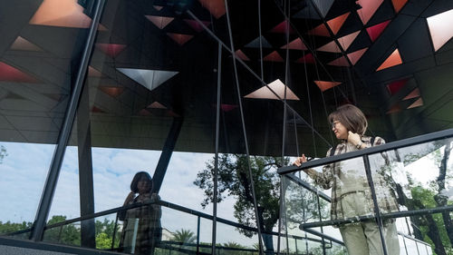 Low angle view of woman standing on slide