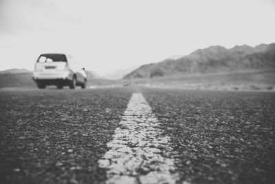 Surface level of road on field against sky