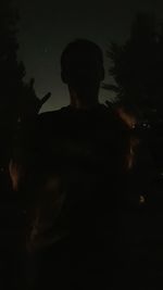 Silhouette man standing at night