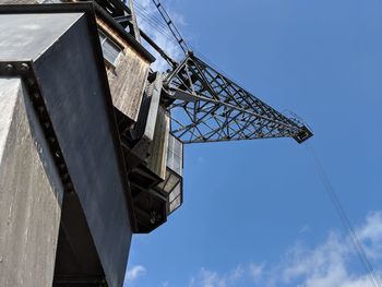 Low angle view of crane against sky