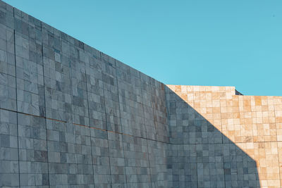 Low angle view of building against clear blue sky