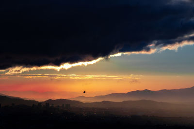 Scenic view of silhouette mountains against sky during sunset