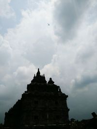 Low angle view of historic building against cloudy sky