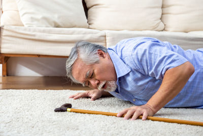 Portrait of man relaxing on sofa at home
