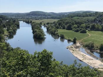 High angle view of lake amidst trees in forest against sky