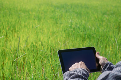 Man using mobile phone on field