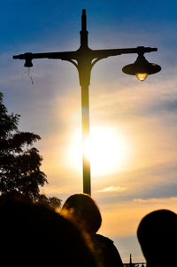 Silhouette of people against sky during sunset