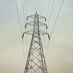 Low angle view of electricity pylon against sky