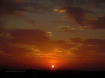 Scenic view of dramatic sky over sea during sunset