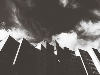 Low angle view of building against cloudy sky