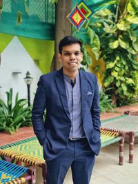 Portrait of young man standing against wall