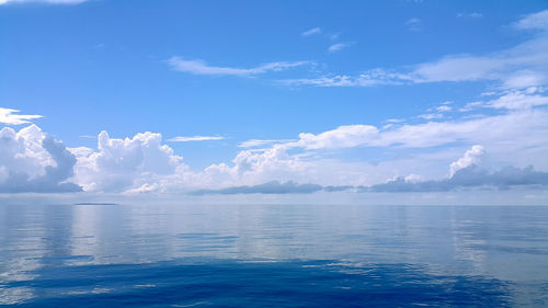 View of calm sea against cloudy sky