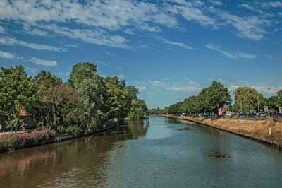 Canal that surrounds the city center of bruges. a town full of canals and old buildings in belgium.