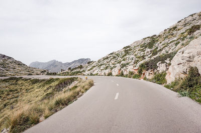 Road amidst mountains against sky