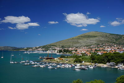 Scenic view of sea and town against sky