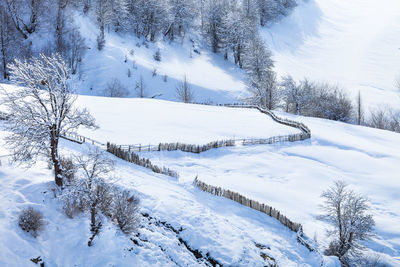 Snow covered landscape against sky